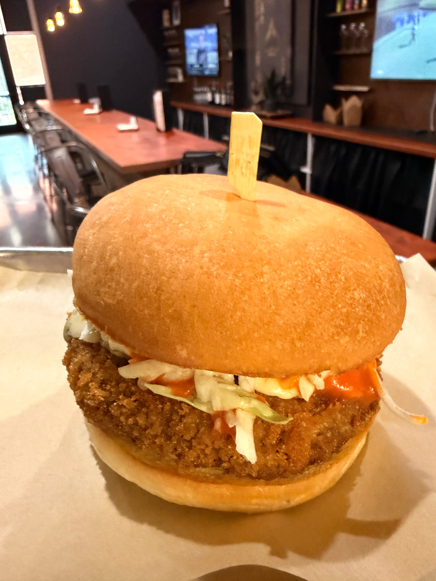 Crispy panko-breaded burger with slaw and house-made buffalo sauce at Burger Fusion